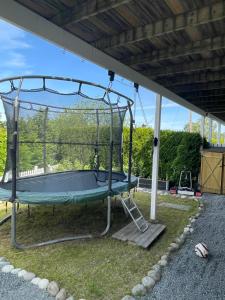 a trampoline in a pavilion in a yard at Nesøya family house in Asker