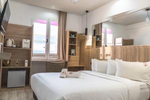 a hotel room with a large bed and a desk at W Hotel Free Jacuzzi & Gym in Dakhla