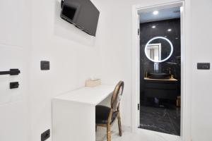 a room with a desk with a chair and a mirror at Cataleya Apartments Makarska in Makarska +42 photos