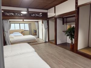 a bedroom with two beds and a large mirror at 旭の屋 in Osaka