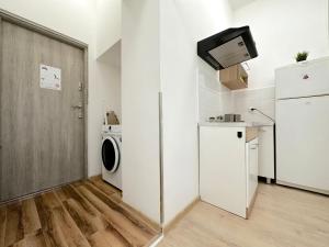 a small kitchen with a washing machine and a refrigerator at Beta Room 10 min to Old Town Gdansk in Gdańsk +10 photos