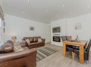 a living room with a couch and a table at 4B City Cottages in Chester