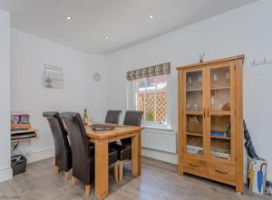 a dining room with a wooden table and black chairs at 4B City Cottages in Chester +17 photos