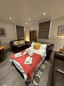 a bedroom with a large bed with towels on it at 4A City Cottages in Chester