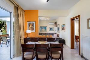 a dining room with a table and some chairs at Euphoria Villa up to 5 in Ialysos +26 photos