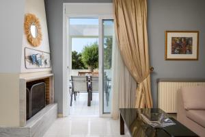 a living room with a fireplace and a couch at Euphoria Villa up to 5 in Ialysos