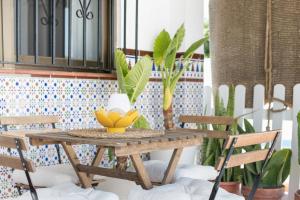 a wooden table with two chairs on a porch at Villa Castro in Vejer de la Frontera