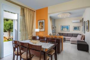 a dining room and living room with a table and chairs at Euphoria Villa up to 5 in Ialysos