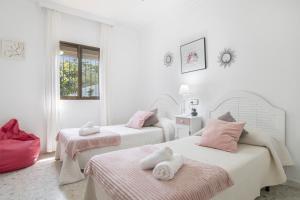 a bedroom with two beds with towels on them at Villa Castro in Vejer de la Frontera +19 photos