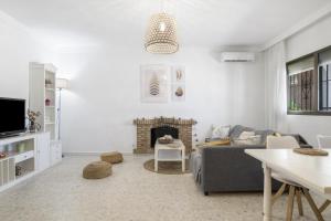 a living room with a couch and a fireplace at Villa Castro in Vejer de la Frontera