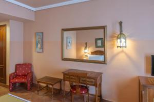 a room with a mirror and a desk and a chair at Moon Dreams El Cortijo in Matalascañas