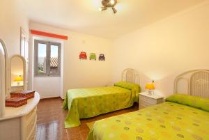 a bedroom with two beds and a window at Gruat 31 in Pollença