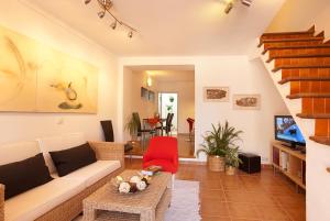 a living room with a couch and a tv at Gruat 31 - Vallem Properties in Pollença