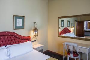 a hotel room with a bed and a mirror at Moon Dreams El Cortijo in Matalascañas