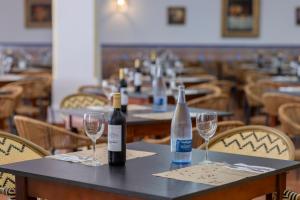 two bottles of wine sitting on a table with glasses at Moon Dreams El Cortijo in Matalascañas