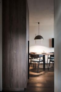 a dining room with a table and aendant light at Bella Posta Premium Apartments in Soprabolzano +33 photos