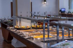a buffet line with many trays of food at Moon Dreams El Cortijo in Matalascañas