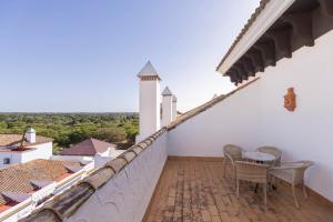 a balcony with a table and chairs on a building at Moon Dreams El Cortijo in Matalascañas
