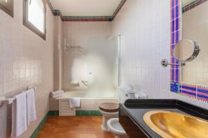 a bathroom with a tub and a toilet and a sink at Moon Dreams El Cortijo in Matalascañas