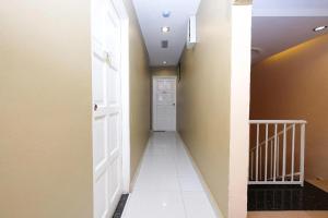 a hallway with a white door and a white tile floor at Heaven Mountain Hill 2 Cameron Highlands in Cameron Highlands
