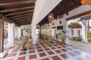an outdoor patio with tables and chairs and a table at Moon Dreams El Cortijo in Matalascañas