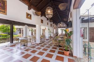 an indoor patio with tables and chairs in a building at Moon Dreams El Cortijo in Matalascañas