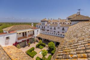 an aerial view of a building with roofs at Moon Dreams El Cortijo in Matalascañas
