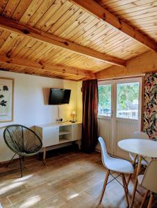 a living room with a table and chairs and a tv at Gaviota Beach Chiclana in Chiclana de la Frontera