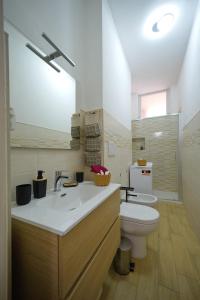 a bathroom with a toilet and a sink and a mirror at Casa Diamante in Turin