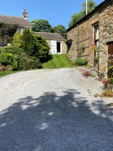 a large shadow of a tree on a driveway at Garden Room in Hope