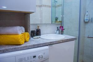 a bathroom with a sink and a shower at Black sea Narcissus - quiet studio with amazing sea view in Varna City +30 photos
