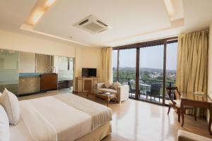 a hotel room with a bed and a living room at The BellaVista Hotel Chandigarh Panchkula in Chandīgarh +38 photos