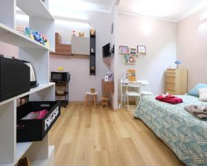 a small room with a bed and a table at Casa Diamante in Turin