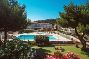 a view of a resort with a swimming pool at Appartement climatisé Résidence Goélia Les Jardins De Phoebus in Gruissan