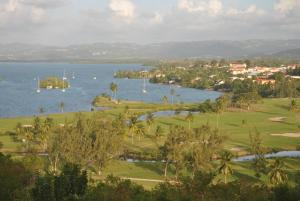 a view of a golf course and a lake at CoCoKreyol - " GRENADINE " in Les Trois-Îlets