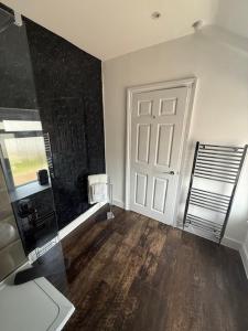 a room with a white door and a wooden floor at Room above the Inn in Bristol +7 photos