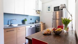 a kitchen with a wooden table with a bowl of fruit on it at Italianway - Tadino 1 A in Milan