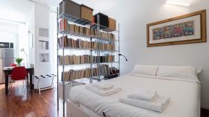 a bedroom with a book shelf filled with books at Italianway - Tadino 1 A in Milan