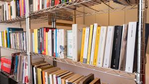 a bunch of books on shelves in a library at Italianway - Tadino 1 A in Milan