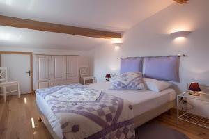 a bedroom with a large bed with blue accents at La Cave de Lami vue sur vignoble in La Digne-dʼAval