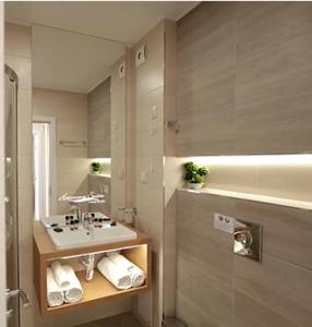 a bathroom with a sink and a mirror at Harmony Suites Grand Resort 16 in Sunny Beach