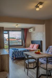 a hotel room with a bed and a table and a bed at Globus Kiten in Kiten