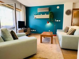 a living room with two couches and a blue wall at 1 Bed Boutique-style Apartment in São Martinho do Porto