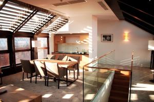 a dining room and kitchen with a table and chairs at Great Polonia The Granary La Suite Hotel in Wrocław