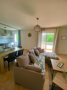 a living room with a couch and a table at Cozy apartment in Château-Arnoux-Saint-Auban