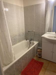 a bathroom with a bath tub and a sink at Cozy apartment in Château-Arnoux-Saint-Auban