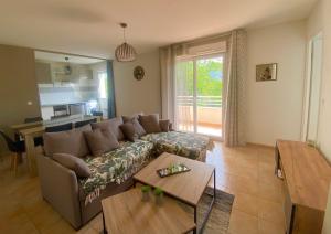 a living room with a couch and a table at Cozy apartment in Château-Arnoux-Saint-Auban