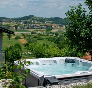 a hot tub on a patio with a view at Apartman Lara in Krapina
