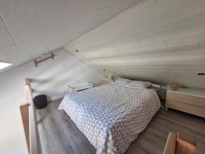 a bedroom with a white bed in a attic at Studio À la Lorette in Rochefort