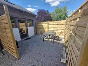 a patio with a table and a fence at Studio À la Lorette in Rochefort